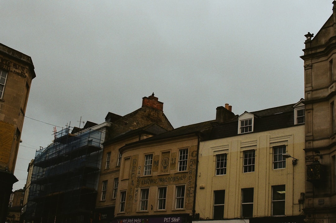 Row of old buildings under a cloudy sky.