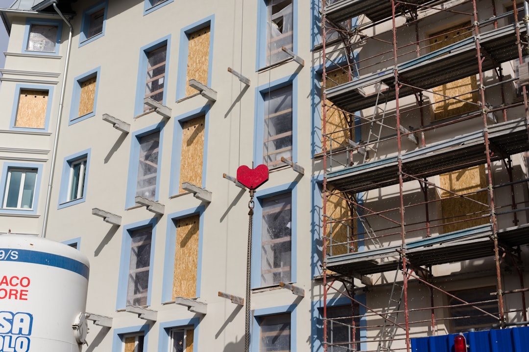 Building with boarded windows and scaffolding