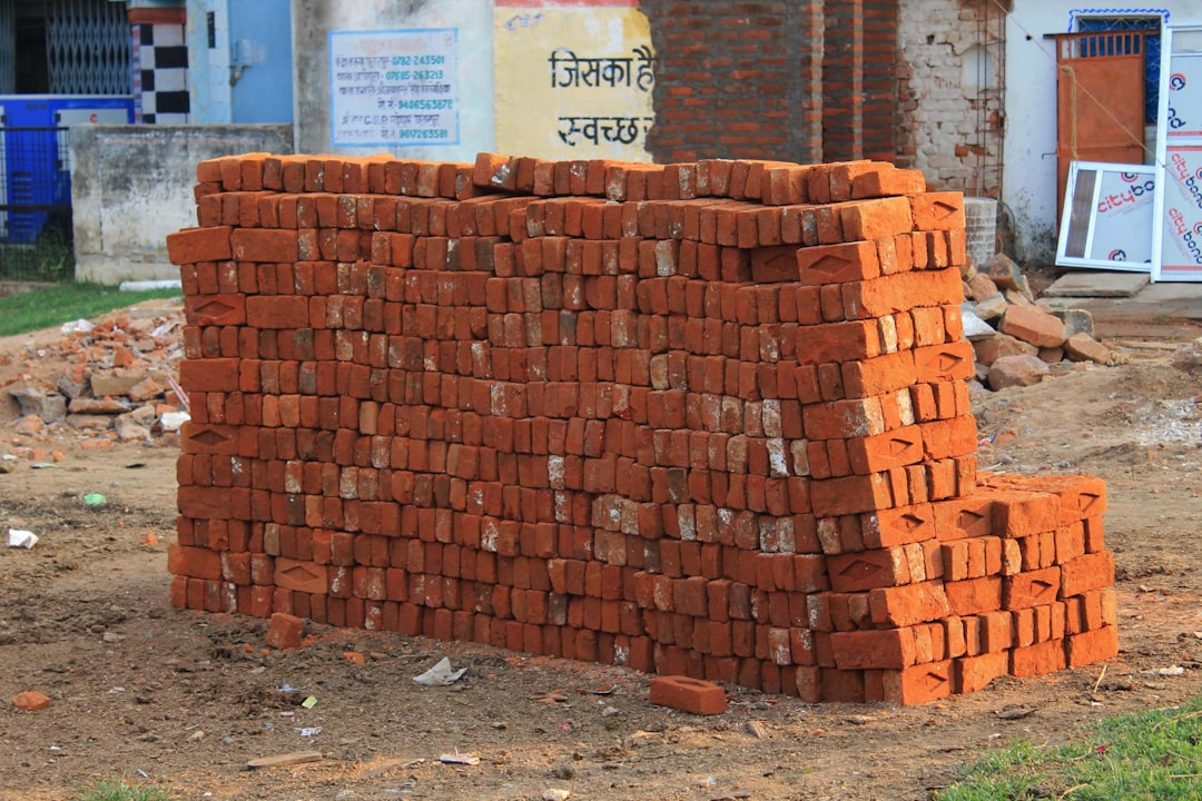 a pile of bricks sitting on top of a dirt field
