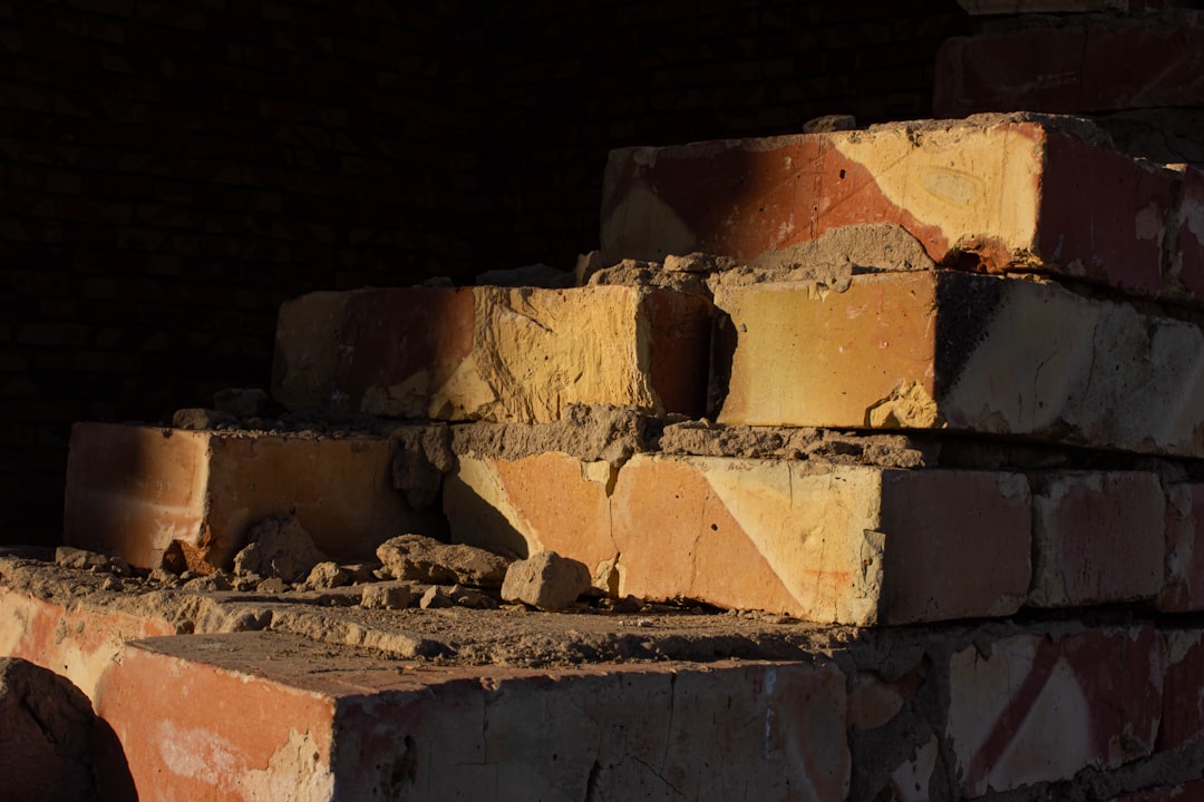a pile of bricks sitting next to a brick wall