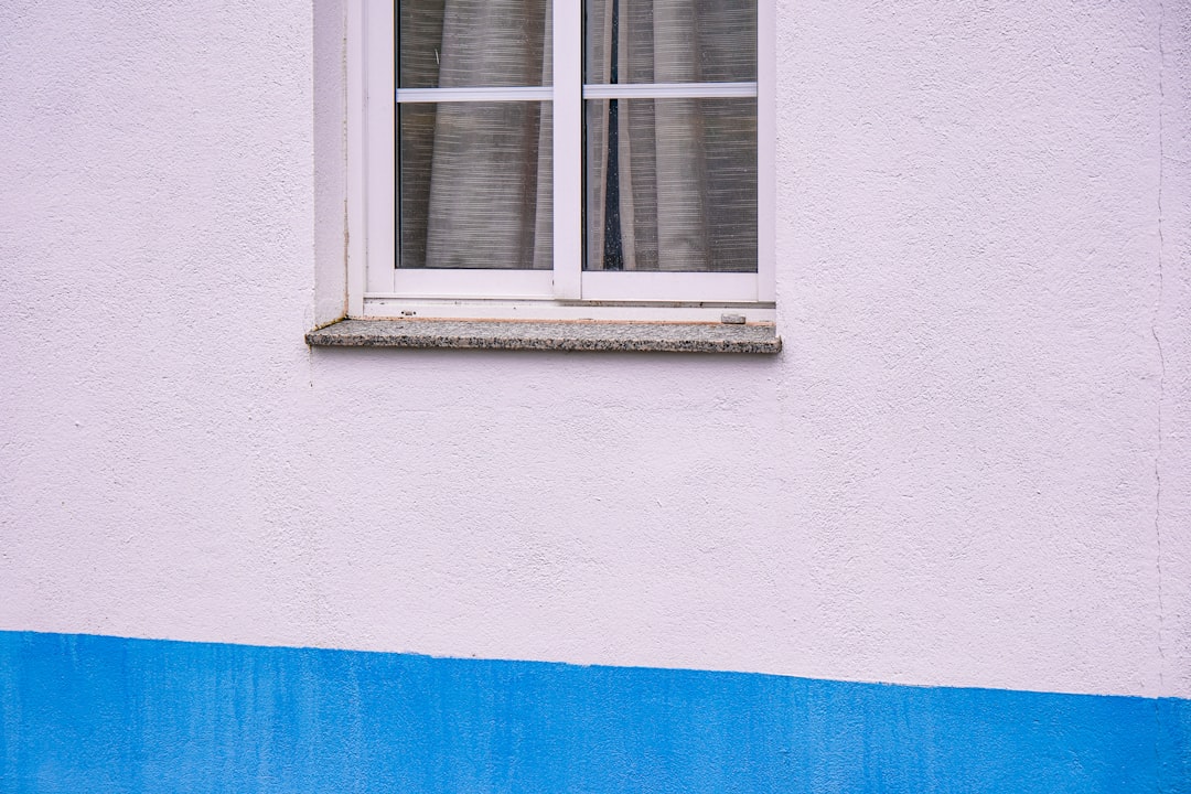 a blue and white building with a window