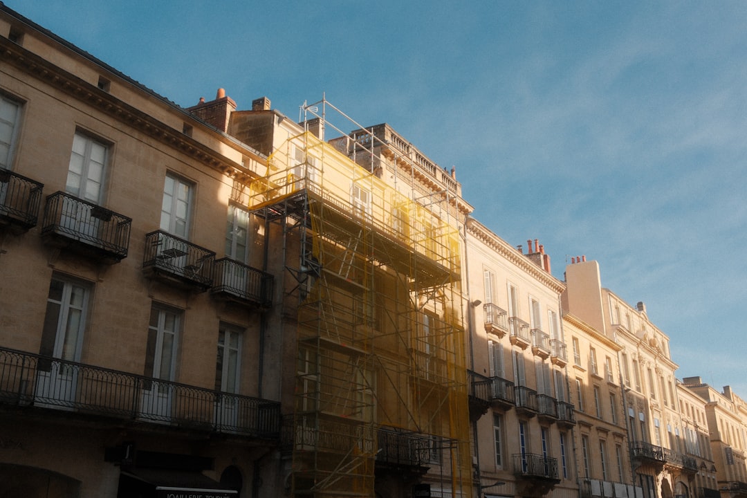 Building facade with scaffolding against blue sky.
