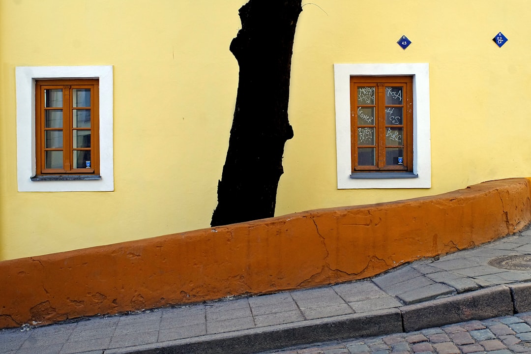 man in black robe standing on gray concrete floor during daytime