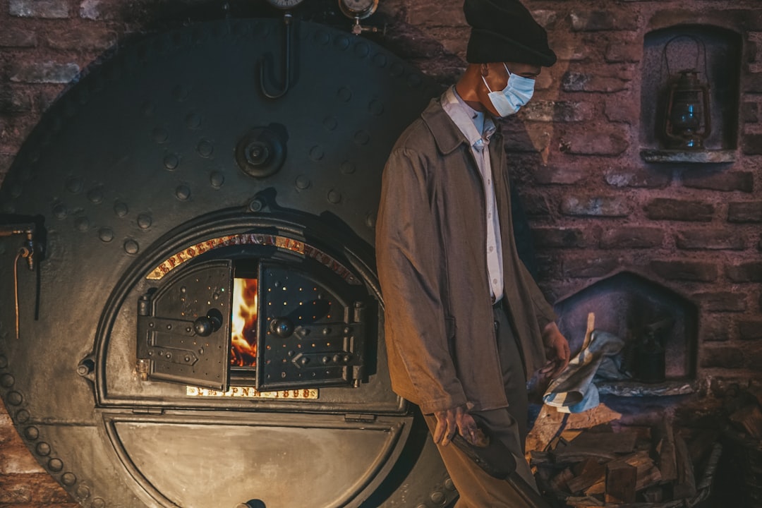 a man standing in front of a large oven