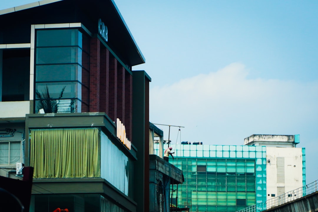 Modern buildings against a clear blue sky.