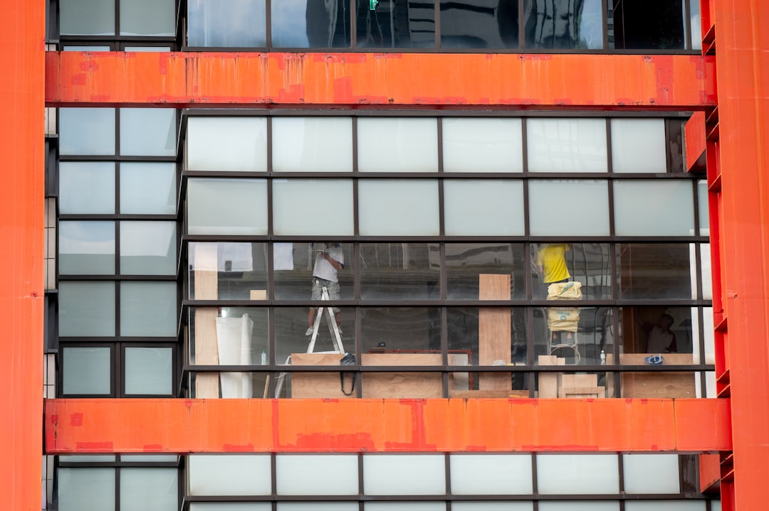 Modern building exterior with orange accents and glass windows